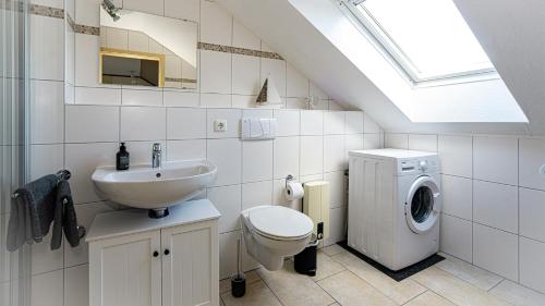 a bathroom with a sink and a washing machine at Schöne gemütliche Wohnung in Marl in Marl