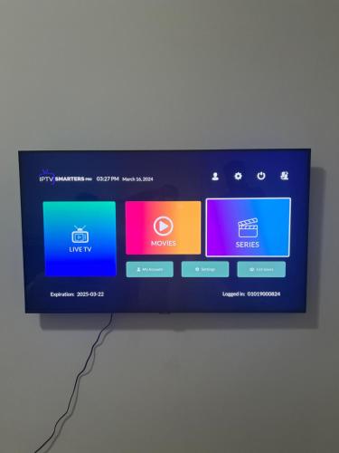a television screen with different colored screens on a wall at F30,R3,Sunrise on the beach,1room inside 3bedroom apartment,(separate washroom outside) in Ajman 