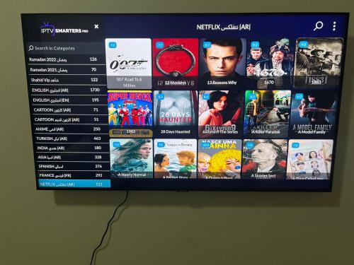a television screen with a bunch of movies on it at F30,R3,Sunrise on the beach,1room inside 3bedroom apartment,(separate washroom outside) in Ajman 