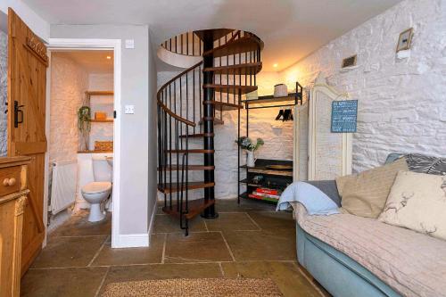 a spiral staircase in a living room with a couch at Finest Retreats - Millgate in Richmond