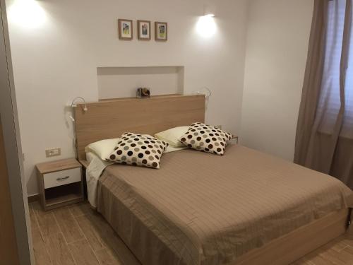 a bedroom with a bed with two pillows on it at Apartment Remy in Pula