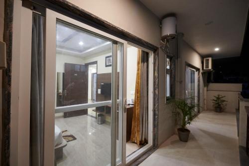 a hallway with a sliding glass door in a house at The Indian Hotel Near Medanta Hospital in Gurgaon