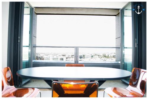 a table and chairs in a room with a large window at Eurosky Twelve in Rome
