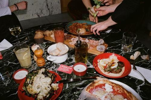 a table topped with plates of food on top at MOB HOTEL Lyon Confluence in Lyon