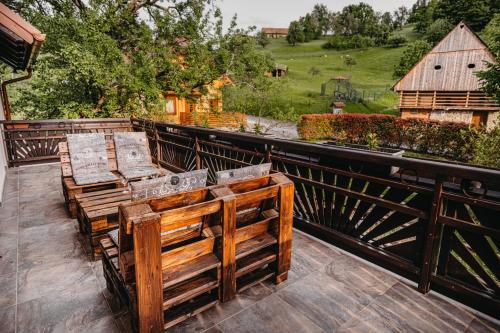 a pair of wooden benches sitting on a balcony at Adventure Farm in Štore