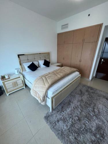 a bedroom with a large bed with a wooden headboard at F30,R3,Sunrise on the beach,1room inside 3bedroom apartment,(separate washroom outside) in Ajman 