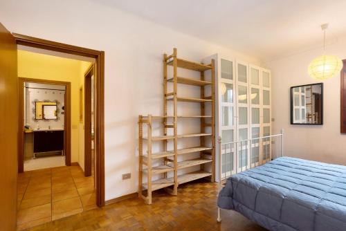 a bedroom with a bed and a book shelf at Casa Express tra Como e Milano in Saronno