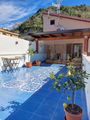 a villa with a blue tile floor and a house at B&B La Filanda in Scilla