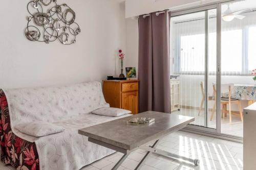 un salon avec un canapé et une table dans l'établissement Close to the port and the beach!, à Frontignan