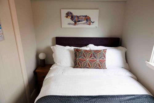 a bedroom with a bed with a picture of a dog at Floating Home at Burton Waters in Lincoln