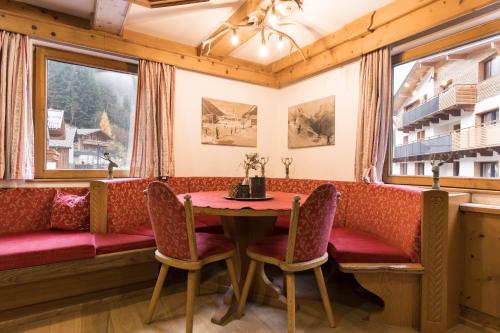 a dining room with a table and chairs and a window at Aparthotel Herzblick GmbH in See