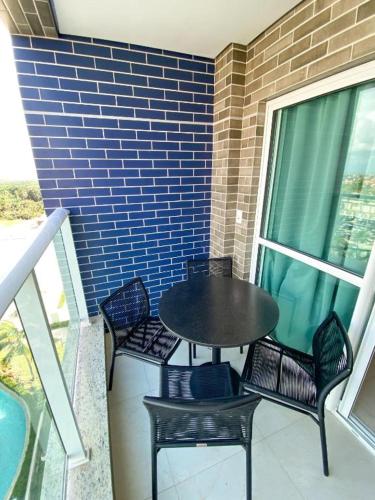 a black table and chairs on a balcony with a table and chairs at Salinas Exclusive Resort in Salinópolis