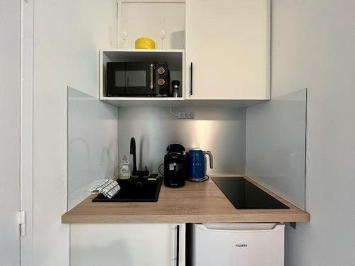 Η κουζίνα ή μικρή κουζίνα στο Studio Aracaju - Parking