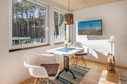 a room with a table and chairs and windows at Krebssee in Ueckeritz