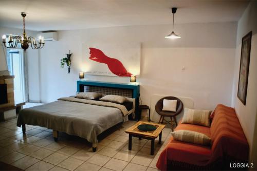 a bedroom with a bed and a couch at Loggia Motovun in Motovun