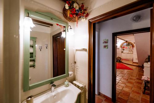 a bathroom with a sink and a mirror at Appartamento Il Papavero Rosso in Grosseto