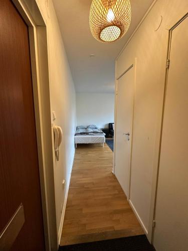 a hallway with a bed in a room at Beautiful And Comfortable Apartment in Gothenburg