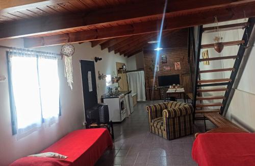 a bedroom with a bed and a living room at Rincón Mágico in Trelew