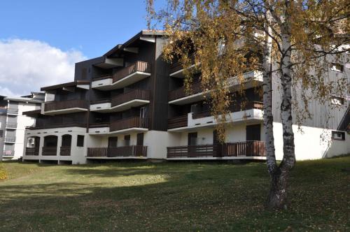 an apartment building with a tree in front of it at Meije 15 - A2 - Appart vue degagee- 6 pers in Les Deux Alpes