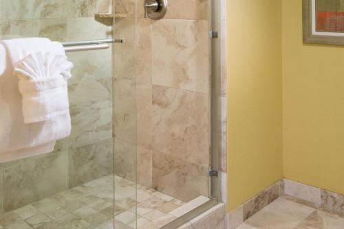 a shower with a glass door in a bathroom at Residence Inn by Marriott St. Petersburg Treasure Island in St. Pete Beach