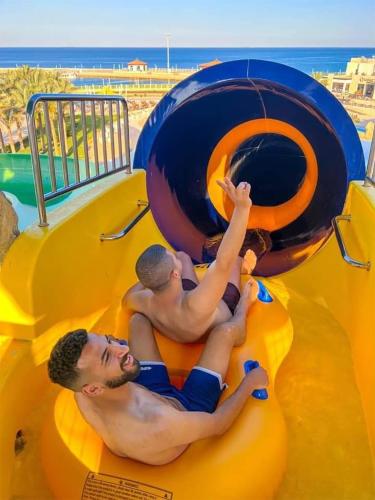 two men sitting on a slide at the beach at Eastern El-Galala Aquapark Ain Sokhna in Ain Sokhna