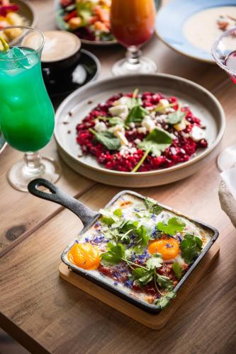 a table with a plate of food and a plate of food at Hotel Bażantowo Sport in Katowice