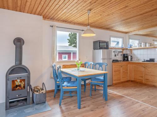 a kitchen and dining room with a table and a wood stove at Ostseeperle - 60730 in Ueckeritz
