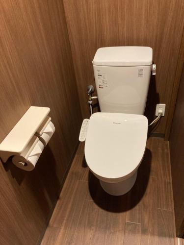 a bathroom with a white toilet in a stall at Guest House Hinode in Takayama