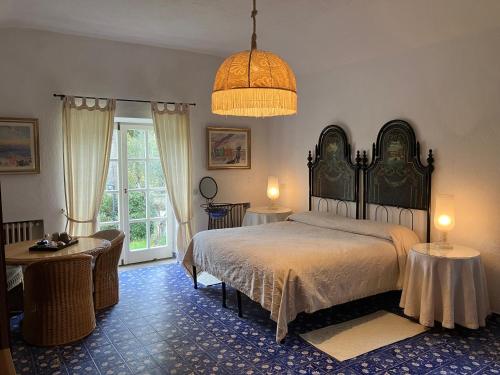 a bedroom with a bed and a large window at Hotel Villa Clementina in Bracciano