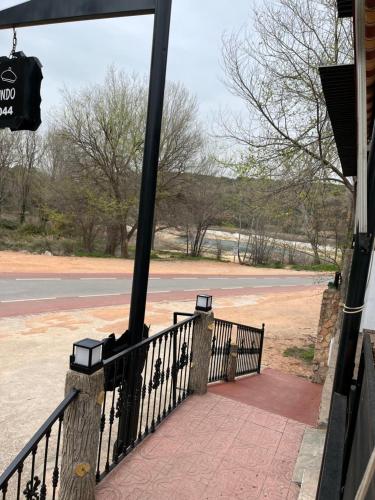a porch with a fence and a street at Casa Rural Abuelo Raimundo in Ossa de Montiel