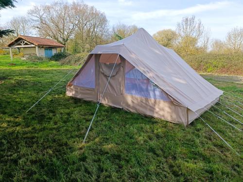 a tent sitting in the grass in a field at Du cote de Roussay in Roussay
