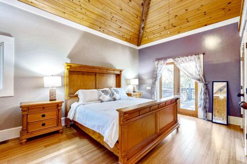 a bedroom with a large bed and a wooden ceiling at Taste of the Tropics in St. Augustine