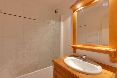 ein Badezimmer mit einem Waschbecken, einem Spiegel und einer Badewanne in der Unterkunft Cabourg - 33 - Studio bonne expo - 4 pers in Les Deux Alpes