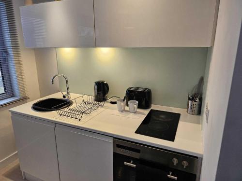 a kitchen with a sink and a counter top at Manor Mills JCS Property in Leeds