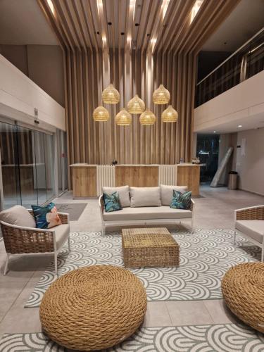 a lobby with couches and chairs in a building at El Samario Cumbia Host-Playa Salguero- Santa Marta in Gaira