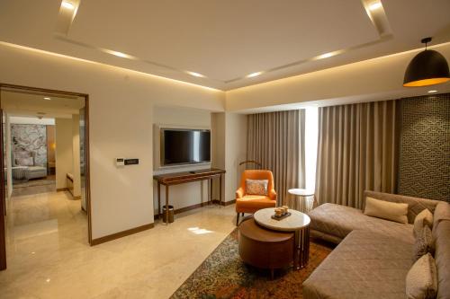 a living room with a couch and a tv at ARISTA BY AMBITION in Guwahati