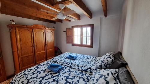 um quarto com uma cama e um armário de madeira em Inviting 1-bed house 'Esquina' Finca Vistamar em Salobre