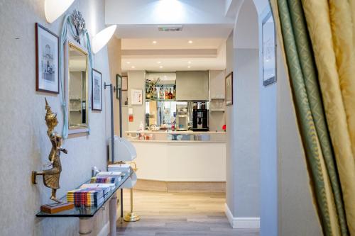 a hallway with a counter with books on it at Hotel Centrale in Bologna