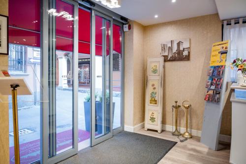 a room with sliding glass doors in a building at Hotel Centrale in Bologna