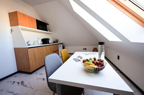 a kitchen with a table with a bowl of fruit on it at RUBO Hotel in Shumen