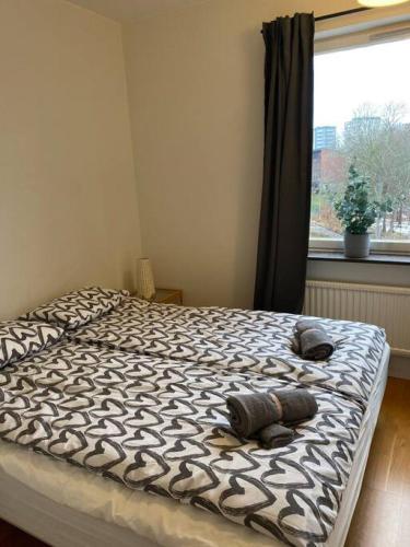 a bedroom with a bed with two pillows and a window at Great 1 bedroom flat on Lidingo in Kottla