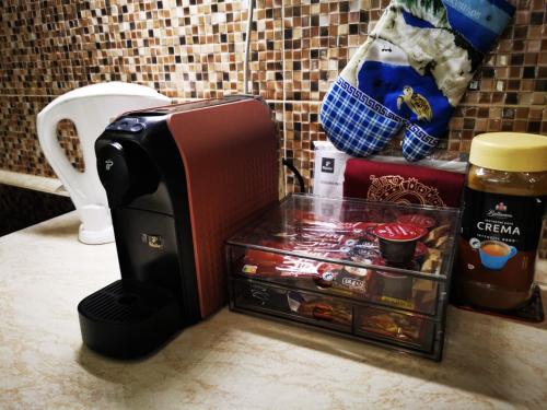 a coffee maker sitting on a counter next to a container at LUX & Comfort in Košice