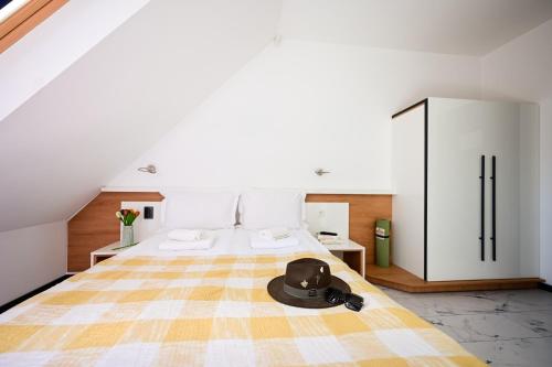 a bedroom with a bed with a hat on it at RUBO Hotel in Shumen