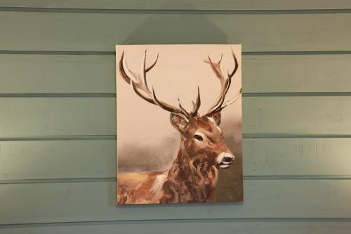 a painting of a deer on a wall at Appin Holiday Homes -Caravans, Lodges, Shepherds Hut and Train Carriage stays in Appin