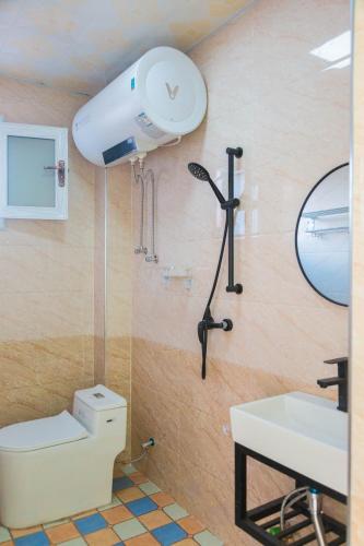 a bathroom with a white toilet and a sink at New Dap Hostel (in Grape Town) in Turfan