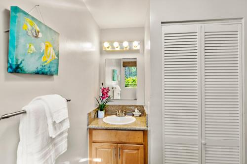 a bathroom with a sink and a mirror at Pohailani 112 in Kahana