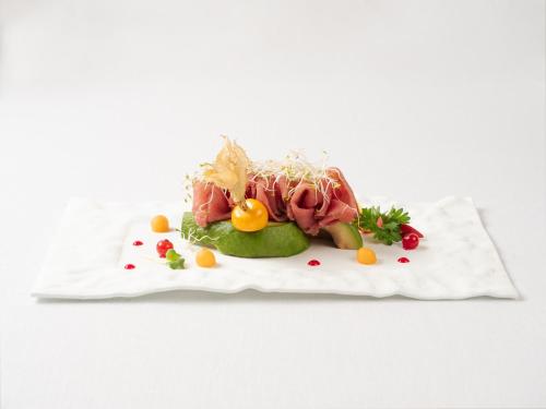 a plate of food with meat and vegetables on it at Albatros Beach Hotel in Letojanni