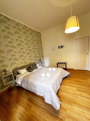 a bedroom with a large white bed in it at Caroline's Home in Castellammare di Stabia
