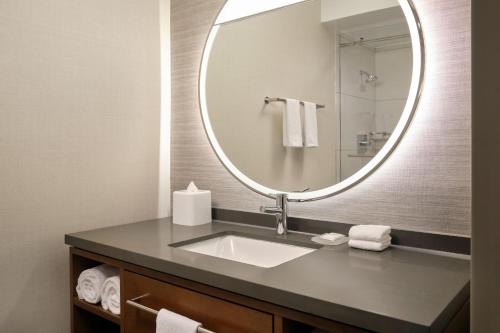 a bathroom with a sink and a mirror at The Bayshore Hotel San Francisco Airport - Burlingame in Burlingame