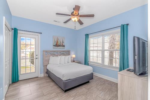 a bedroom with a bed and a ceiling fan at Spacious 4 Bedroom House-2 Blocks From the Ocean-2185 Sanibel Court! in Myrtle Beach
